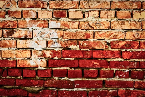 Worn red brick wall hald of deep red color — Stock Photo, Image