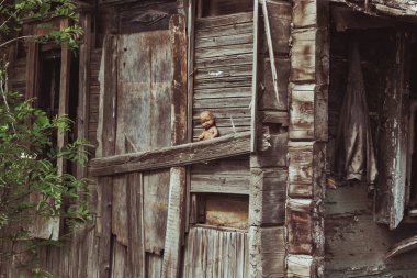 Old destroyed slum house with spooky doll clipart