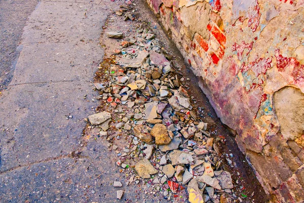 Dirty street with a lot of old plaster chunks on surface