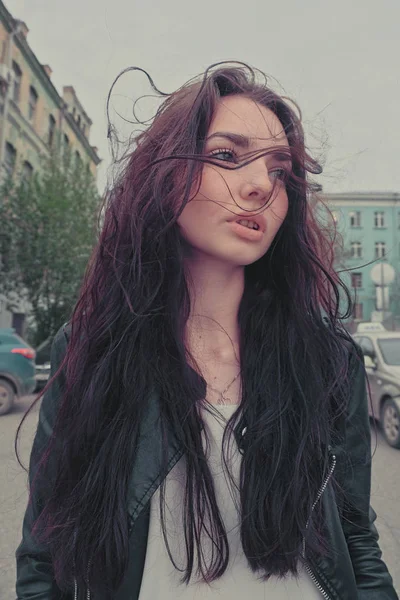 Peaceful good looking girl posing with windy hair ouside, wide anglw smartphone lens imitation image — Stock Photo, Image