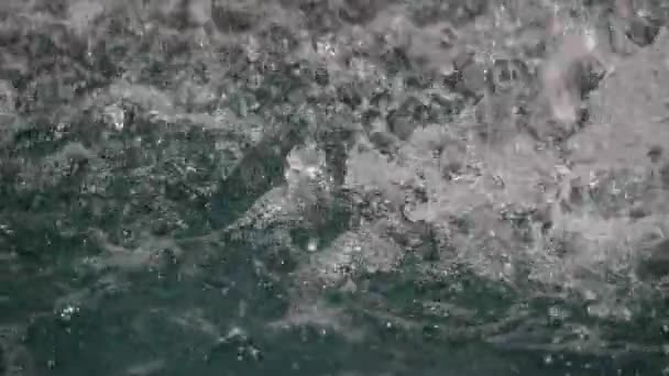 Disturbed by falling water drops surface of the fountain pond slomo — Stock Video
