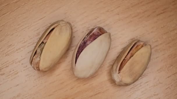 Seller is holding one of Pistachios over the full surface of it. — Stock Video