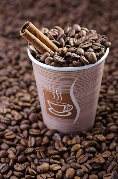 Glass of coffee beans. Dropped brown coffee beans