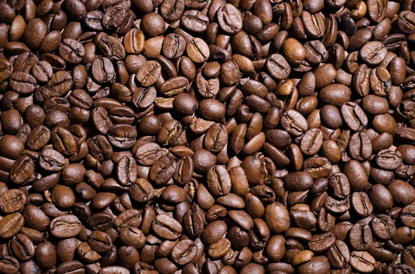 Background of coffee beans. Dropped brown coffee beans.