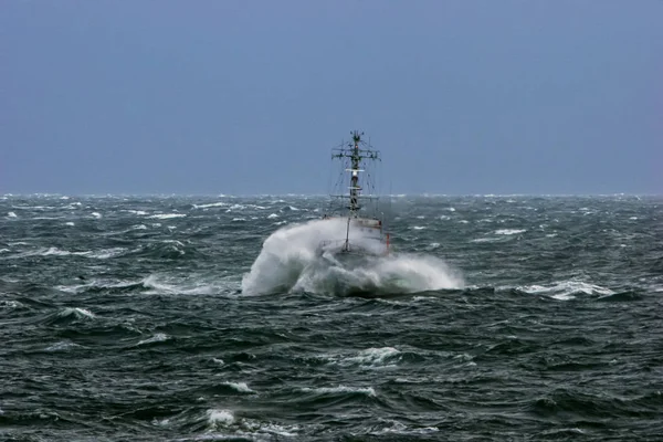 Ship in sea storm. Storm at Baltic sea. Warship training in the Baltic Sea during a storm. NATO military ship in Baltic sea, Latvia. NATO military ship at sea during a storm.