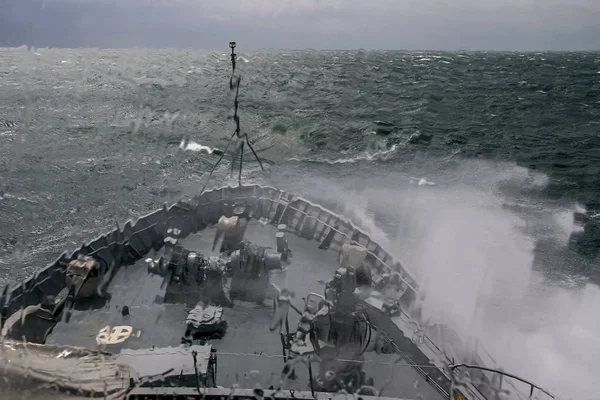 Ship in sea storm. Storm at Baltic sea. Warship training in the Baltic Sea during a storm. NATO military ship in Baltic sea, Latvia. NATO military ship at sea during a storm. view from ships the bow.