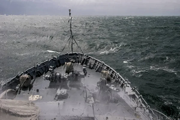 Ship in sea storm. Storm at Baltic sea. Warship training in the Baltic Sea during a storm. NATO military ship in Baltic sea, Latvia. NATO military ship at sea during a storm. view from ships the bow.