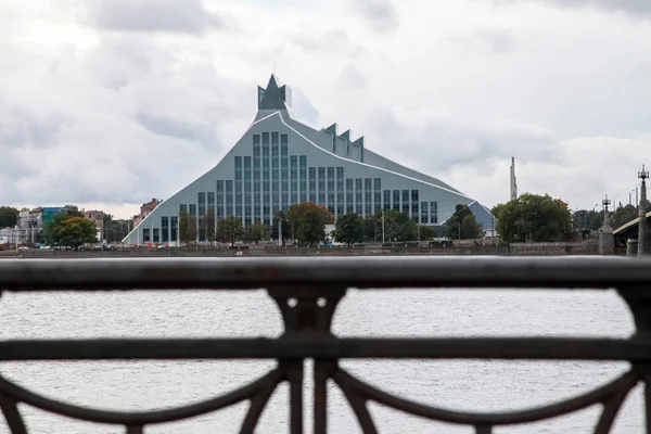 Latvian National Library. Cityscape from November 11 embankment with Latvian National Library in Riga. November 11 embankment bridge railings and National Library. National Library in center of Riga. — Stock Image Latvian National Library Cityscape November Embankment Latvian National Library Riga Stock Image