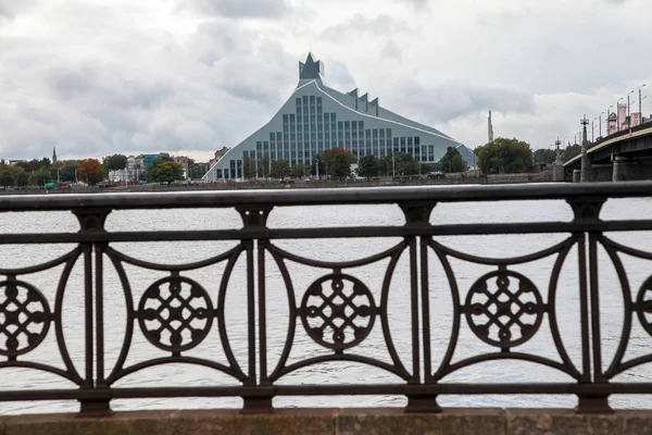 Latvian National Library. Cityscape from November 11 embankment with Latvian National Library in Riga. November 11 embankment bridge railings and National Library. National Library in center of Riga. — Stock Image Latvian National Library Cityscape November Embankment Latvian National Library Riga Stock Picture