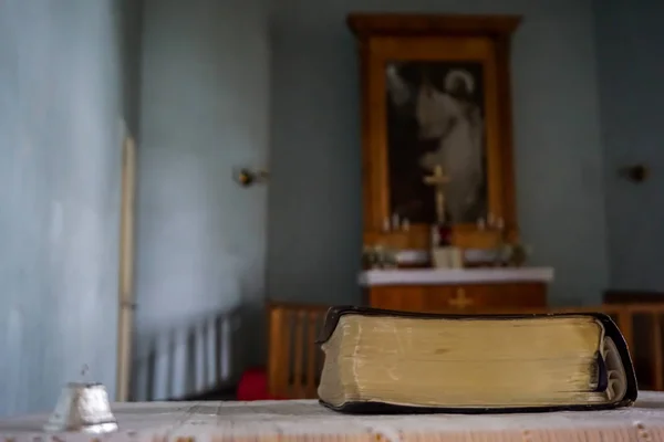 Evangelic Lutheran Church in Koknese, Latvia. Interior of Koknese church. Bible and bell at the Koknese Evangelical Lutheran Church. Church was built in 1687.