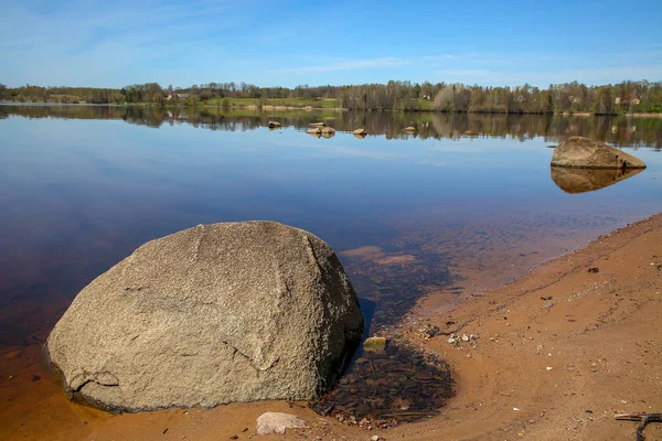 Natural big river Daugava landscape with natural big stones and ruins in Latvia. Koknese castle ruins. Latvian medieval castles. Archaeological monument of national importance