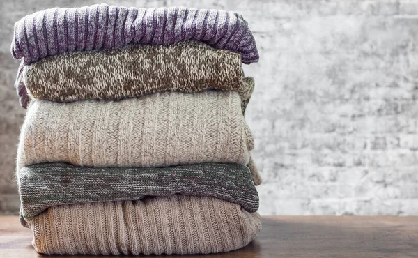 Stack Cozy Knitted Sweaters Gray Wall Background — Stock Photo, Image