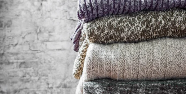 Stack Cozy Knitted Sweaters Gray Wall Background — Stock Photo, Image