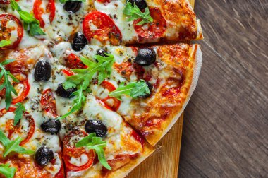 Pizza Margherita veya Mozzarella peyniri, domates, zeytin ile Margarita. Ahşap arka plan üzerinde İtalyan pizza