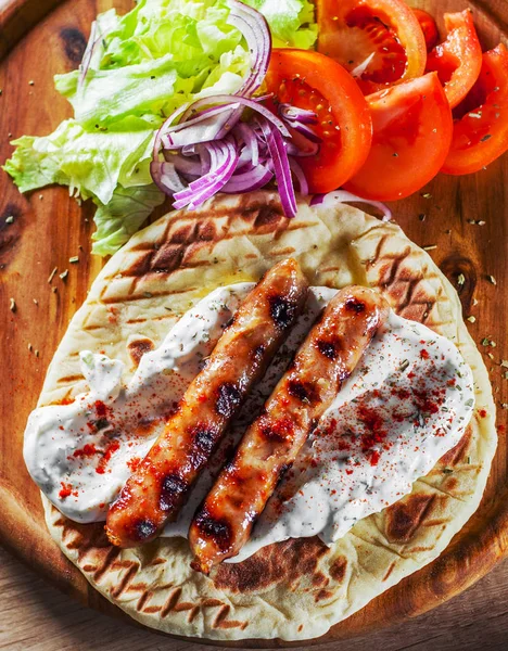 Grilled Meat Sausages Pita Bread Vegetables Salad Tzatziki Dip Wooden — Stock Photo, Image