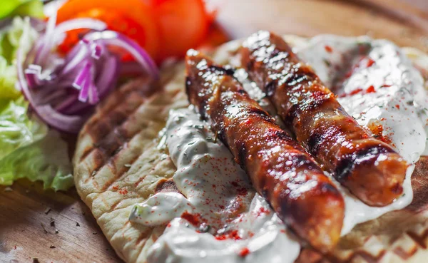 Grilled Meat Sausages Pita Bread Vegetables Salad Tzatziki Dip Wooden — Stock Photo, Image