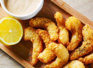 Kızarmış karides sos ve ahşap masa arka plan üzerinde limon ile