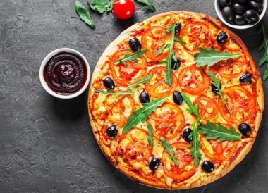 Pizza Mozzarella peyniri, domates, biber, zeytin, baharatlar ve taze roka ile. İtalyan pizza. Pizza Margherita veya koyu gri siyah arduvaz arka plan Margarita