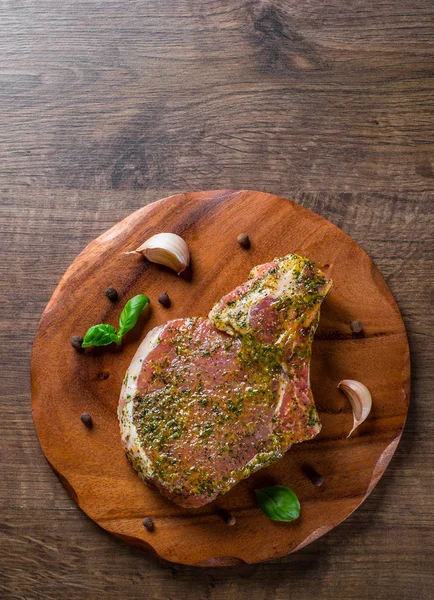 Raw Pork Loin chops marinated meat Steak for bbq on wooden table background