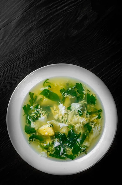Green Sorrel soup in white plate on black wooden table background — Stock Image Green Sorrel Soup White Plate Black Wooden Table Background Stock Photo