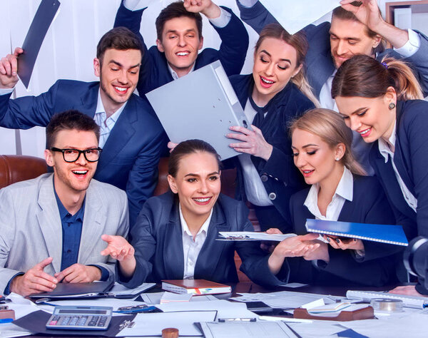 Business people office life of team people are happy with hand up sitting table and working papers. Cabinets with folders and jalousie background. Welcome reception at bank.