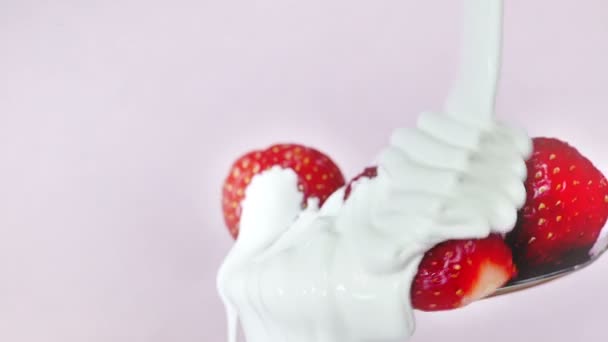 Strawberry dessert with pouring yogurt on moving spoon — Stock Video
