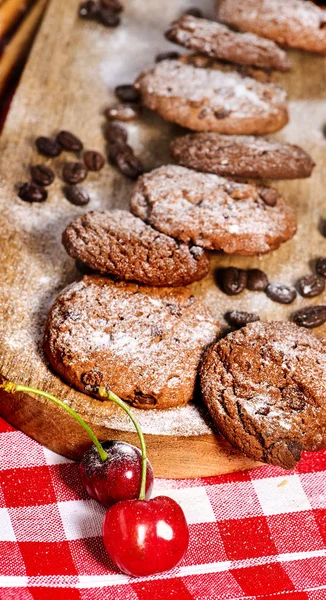 Oatmeal chocolate cookies with coffee grains and cherry. Sun flare