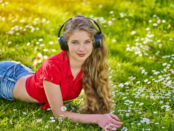 Girl in headphones catch rhythm music on green grass — Stock Photo, Image