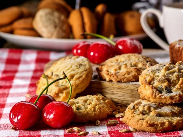Oatmeal cookies snack and cherry breakfast close up — Stock Photo, Image