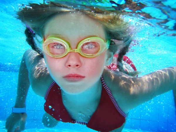 Girl in goggles swim and dive under water. — Stock Photo, Image