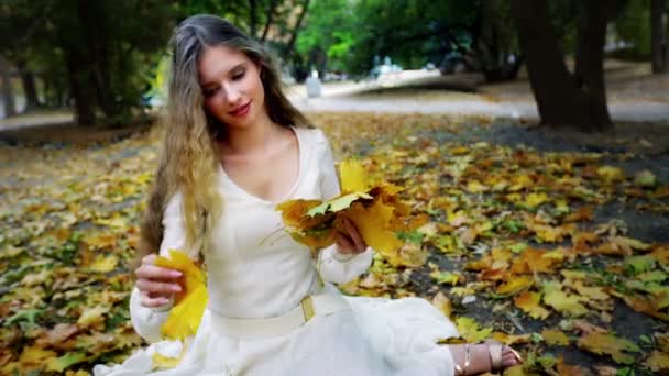 Automne fille dans la mode et les paroles style ramasser feuilles — Video