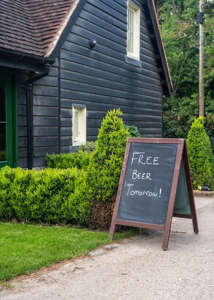 Signpost joke saying Free beer tomorrow — Stock Photo, Image