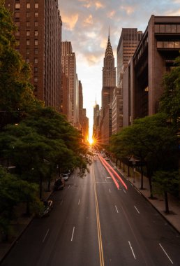 Manhattanhenge when the sun sets along 42nd street in NY clipart