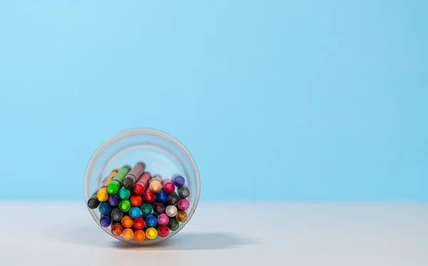 Stack of colorful crayons in cup with copy space — Stock Photo, Image