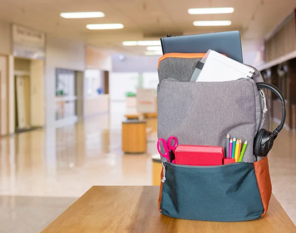 Тяжелый рюкзак со школьными принадлежностями в современном вестибюле — стоковое фото