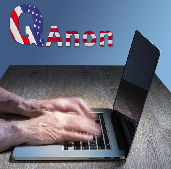 Senior caucasian man types about Q Anon deep state conspiracy — Stock Photo, Image
