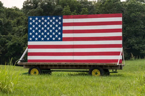 US Stars and Stripes painted on wooden boards in meadow