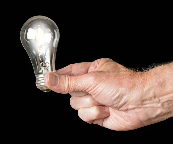 Mans hand holding an illuminated halogen lightbulb — Stock Photo, Image