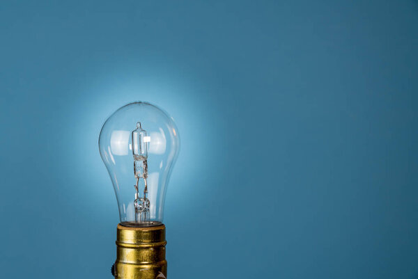 Halogen lightbulb against a blue background