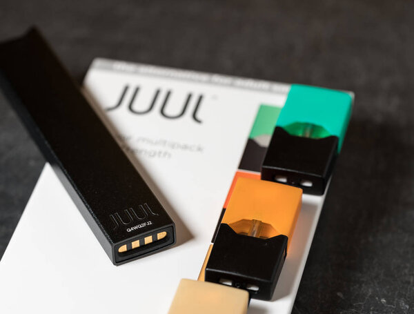 Box holding JUUL nicotine dispenser and pods