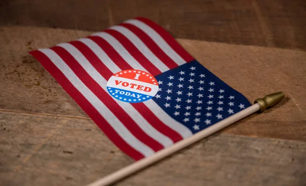 Snävt fokus på jag röstade idag papper klistermärke på oss flagga — Stockfoto