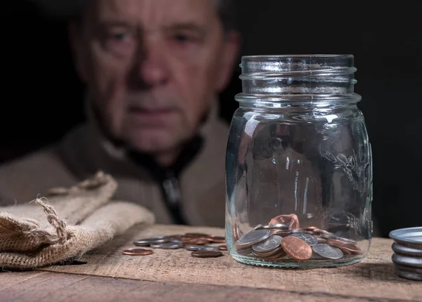 Senior retired caucasian man looking at remaining savings — Stock Photo, Image