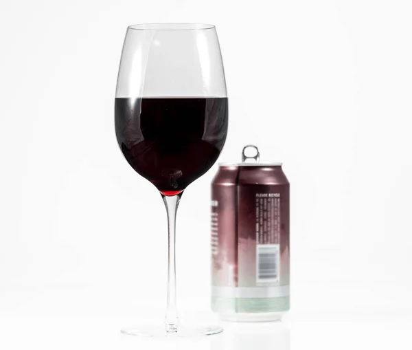 Pinot Noir Rotwein im Weinglas mit einer einzigen Portion Aluminiumdose im Hintergrund — Stockfoto