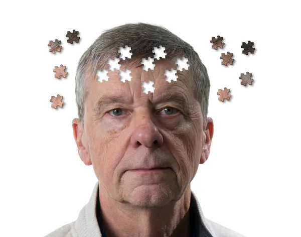 Jigsaw concept of mental illness or dementia with senior caucasian man looking sad into camera — Stock Photo, Image