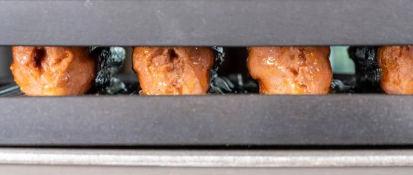 Plant based vegetarian sausages being grilled on griddle — Stock Photo, Image