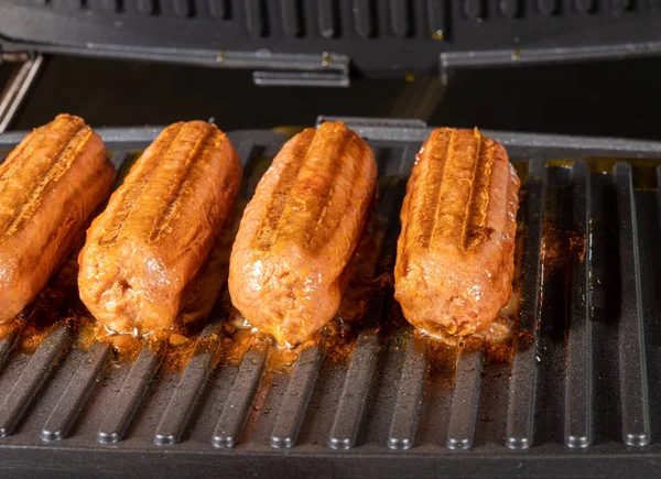 Plant based vegetarian sausages being grilled on griddle — Stock Photo, Image