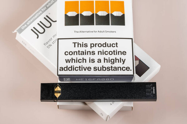 Box holding flavored JUUL nicotine dispenser and pods