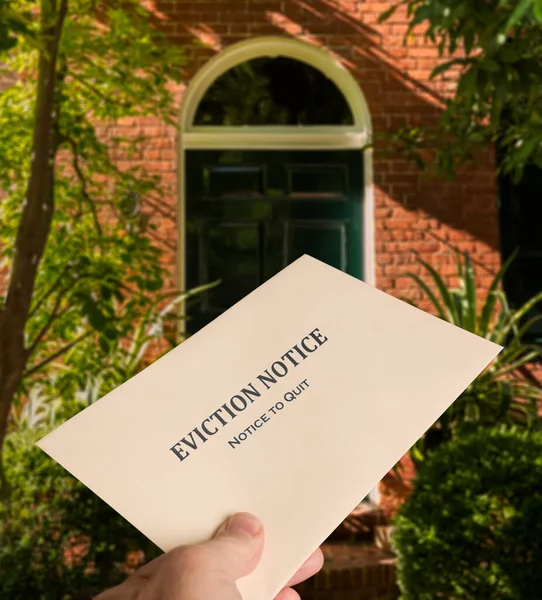 Envelope being hand delivered to house with eviction notice — Stock Photo, Image
