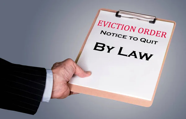 Man in suit giving eviction notice to renter or tenant of home — Stock Photo, Image