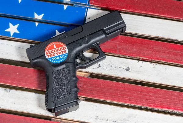 Concept of protecting against voter fraud with firearm and voting sticker — Stock Photo, Image